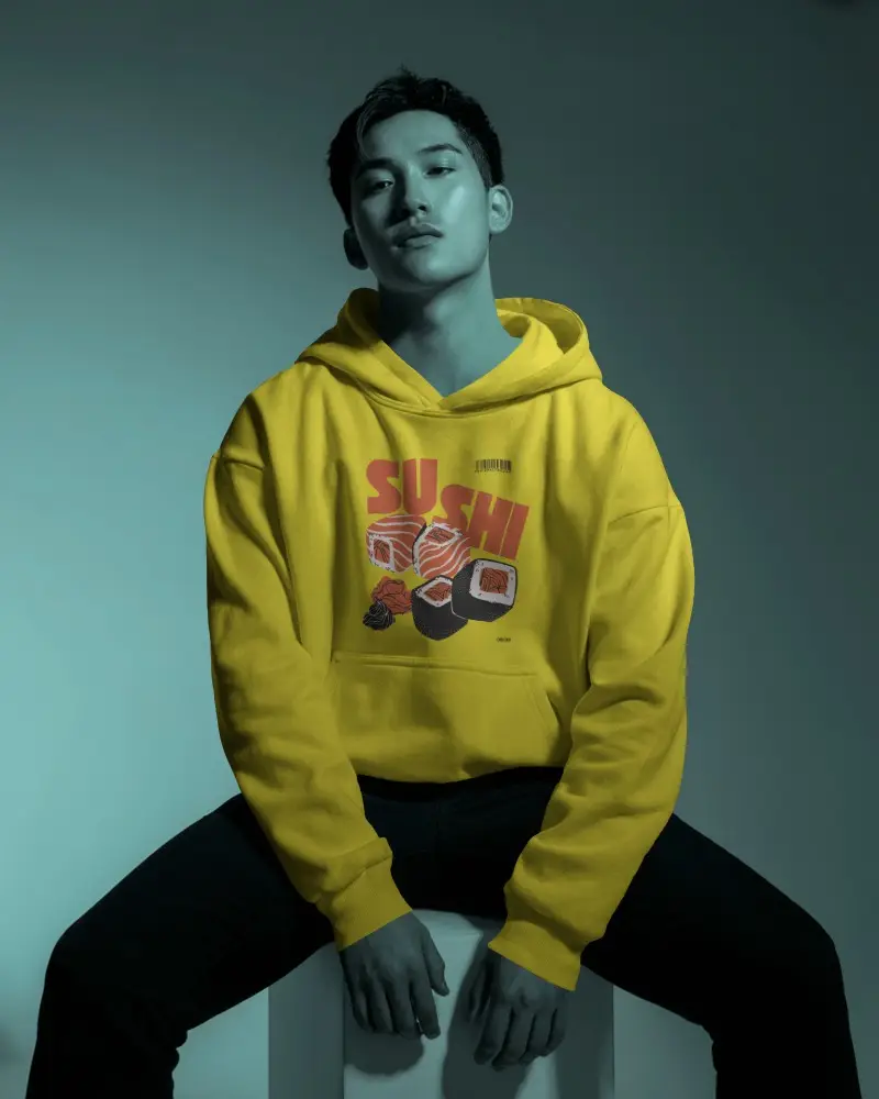 Studio Hoodie Mockup Male Model Sitting In Moody Teal Light With Shadowed Urban Styling