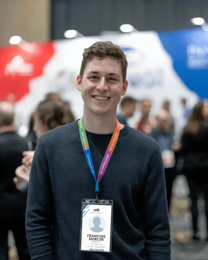 Conference Pass Mockup On Person Wearing Casual Professional Attire In Colorful Busy Event Setting Showcasing Engaging And Modern Brand Design
