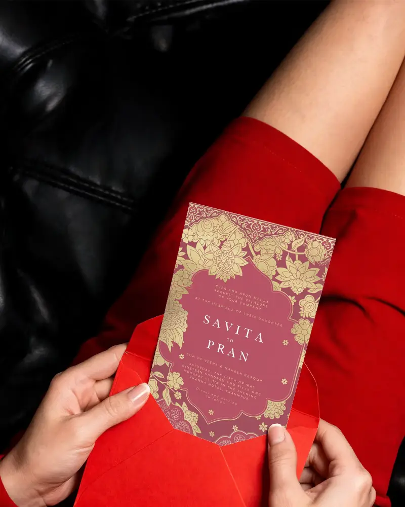Red Envelope Invitation Card Mockup Holding Blank Template On Lap With Leather Sofa