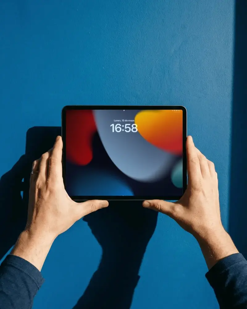 Hands Holding Horizontal Ipad Air Mockup Against Solid Color Background For Ui Design
