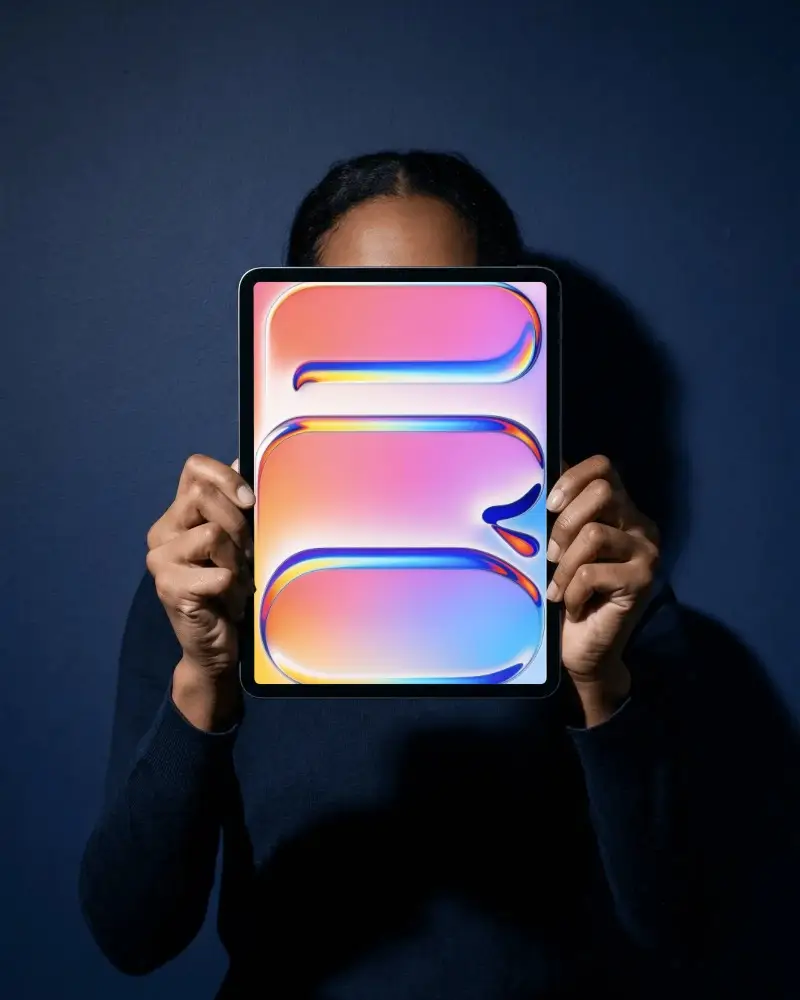 Person Holding Ipad Pro Mockup With Blank Screen Against Dark Background For Creative Content