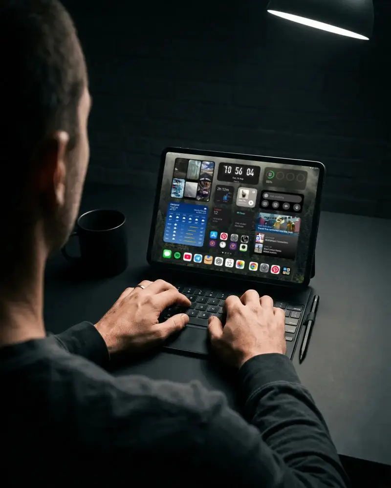 Person Using Ipad Pro With Keyboard And Stylus On Modern Workstation In Minimalist Setting