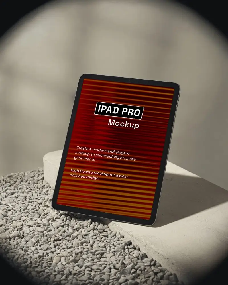 Ipad Pro Mockup On Pebble Surface Leaning Against Minimal Concrete Block