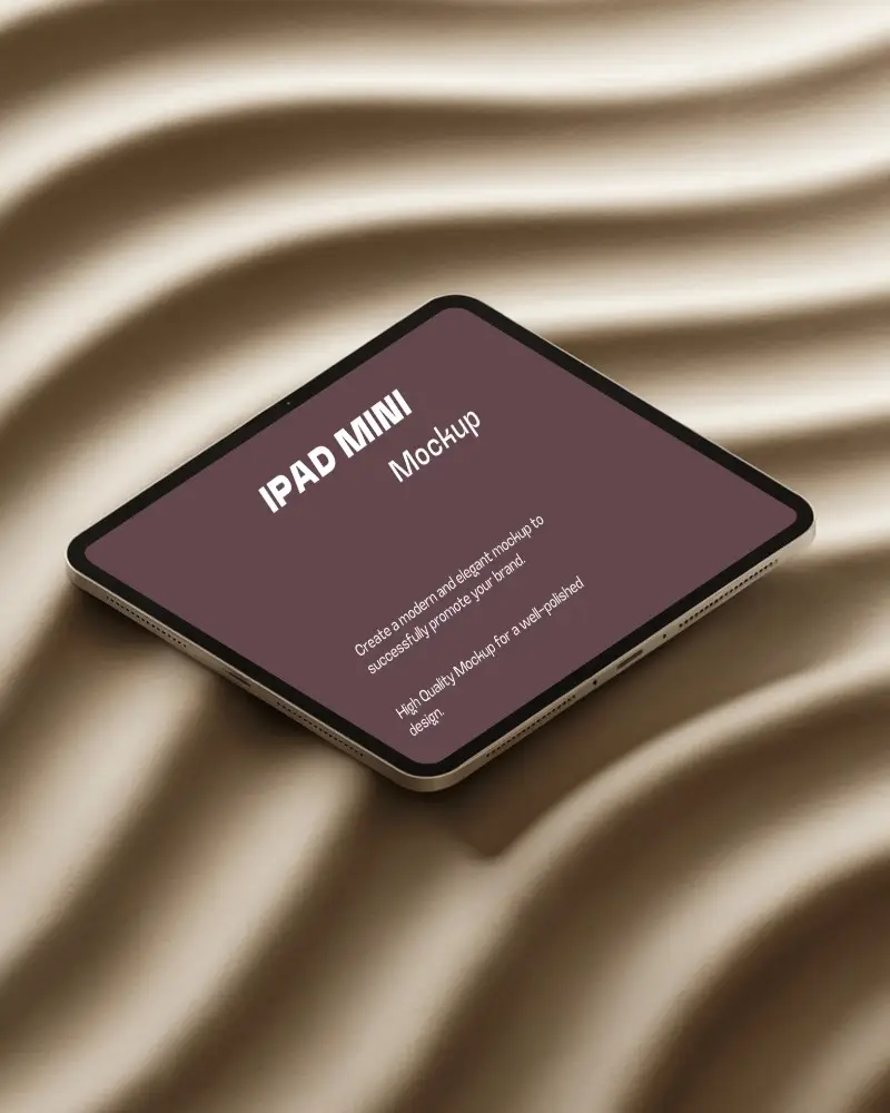 Ipad Mini Mockup Angled Top View On Wavy Sand Texture Surface In Natural Light