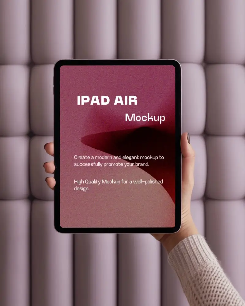 Hand Held Ipad Air Mockup With Soft Focus A Pastel Pink Tufted Wall Background