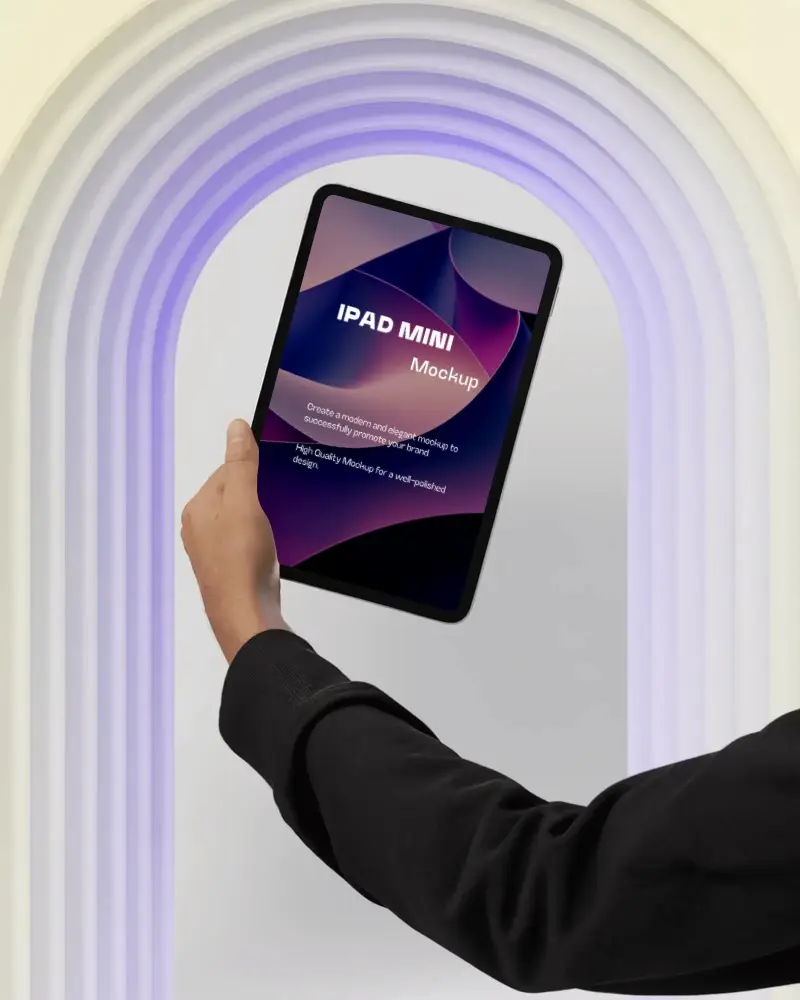 Modern Ipad Mini Mockup With Hand Raised Against Illuminated Archway