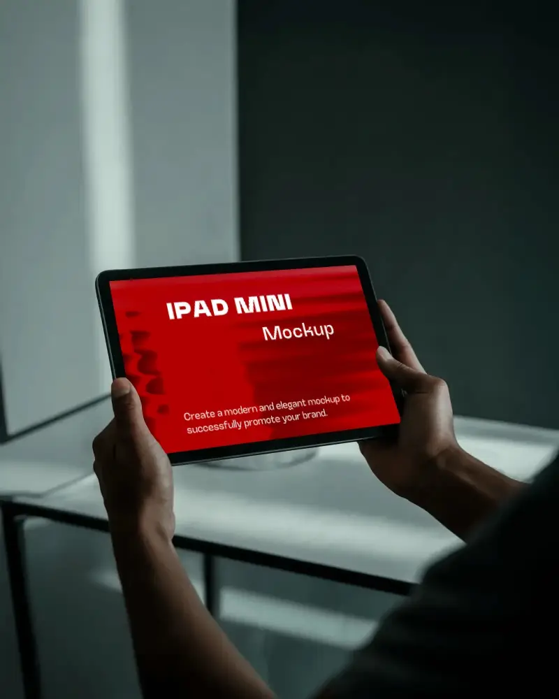 Moody Ipad Mini Mockup Hands Holding Tablet In Dark Toned Environment With Subtle Light