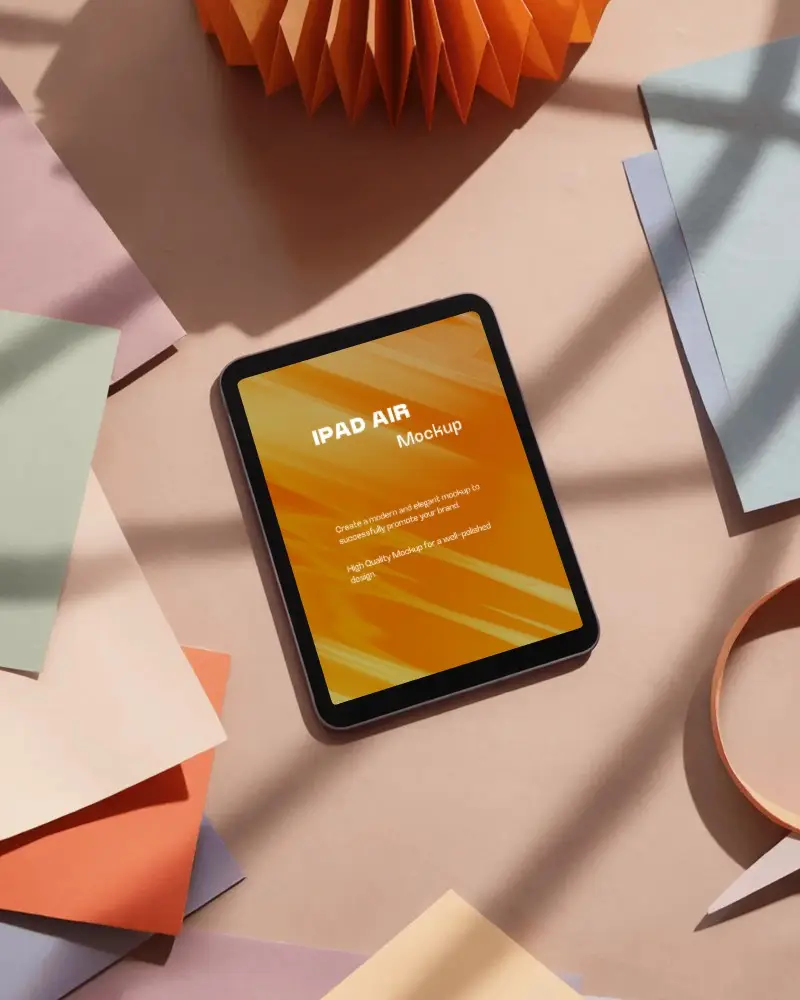 Ipad Air Mockup Top View On Pastel Desk With Colorful Paper Sheets And Soft Sunlight