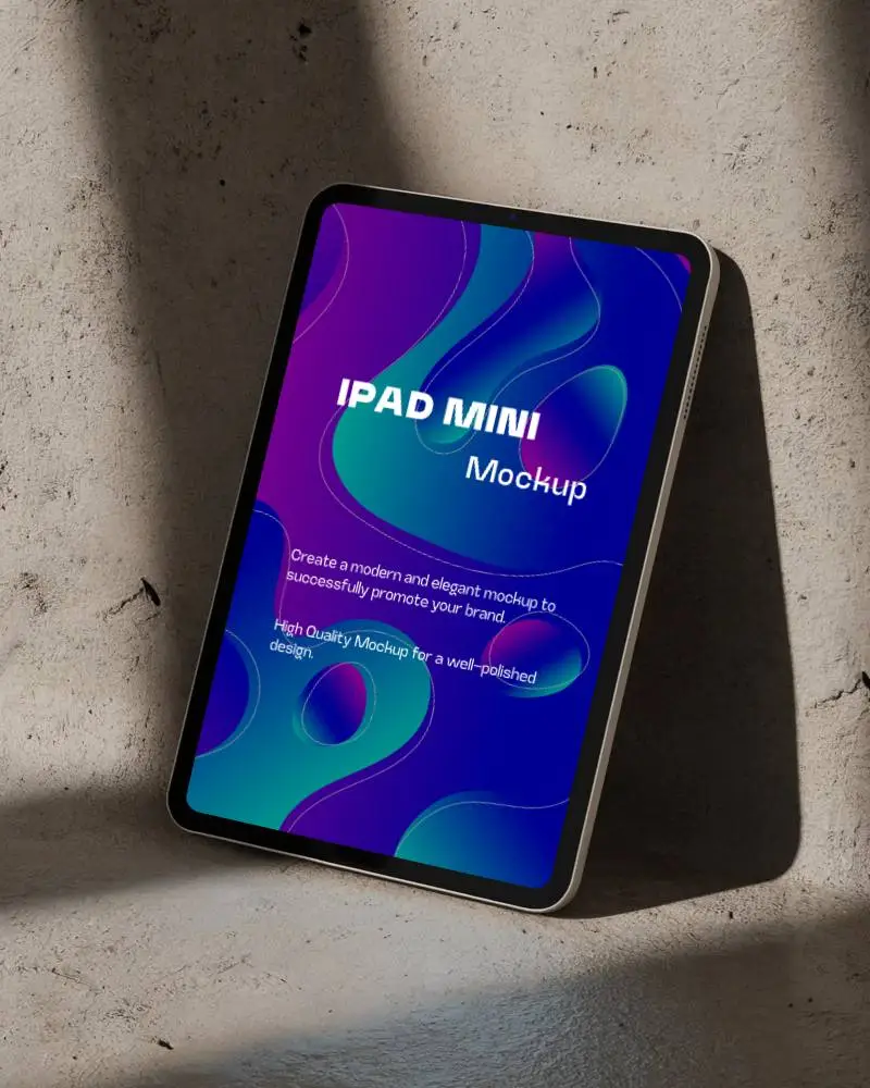 Ipad Mini Mockup Leaning Against Concrete Wall With Soft Directional Lighting And Neutral Tones