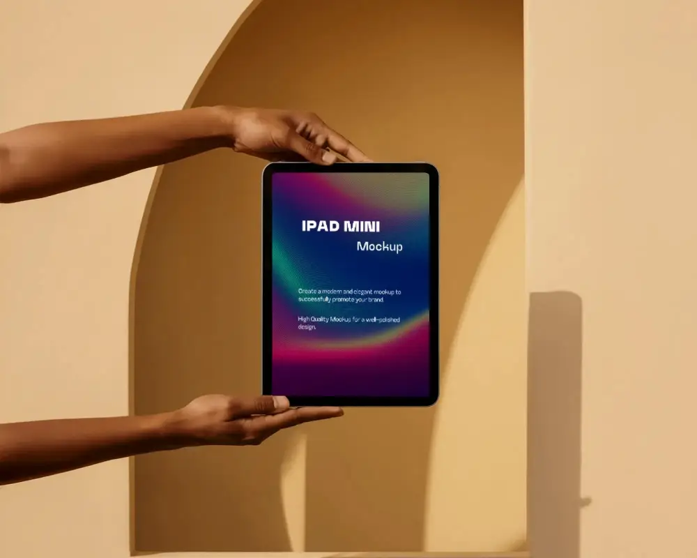 Vertical Ipad Mini Mockup Held With Two Hands On Beige Architectural Setting