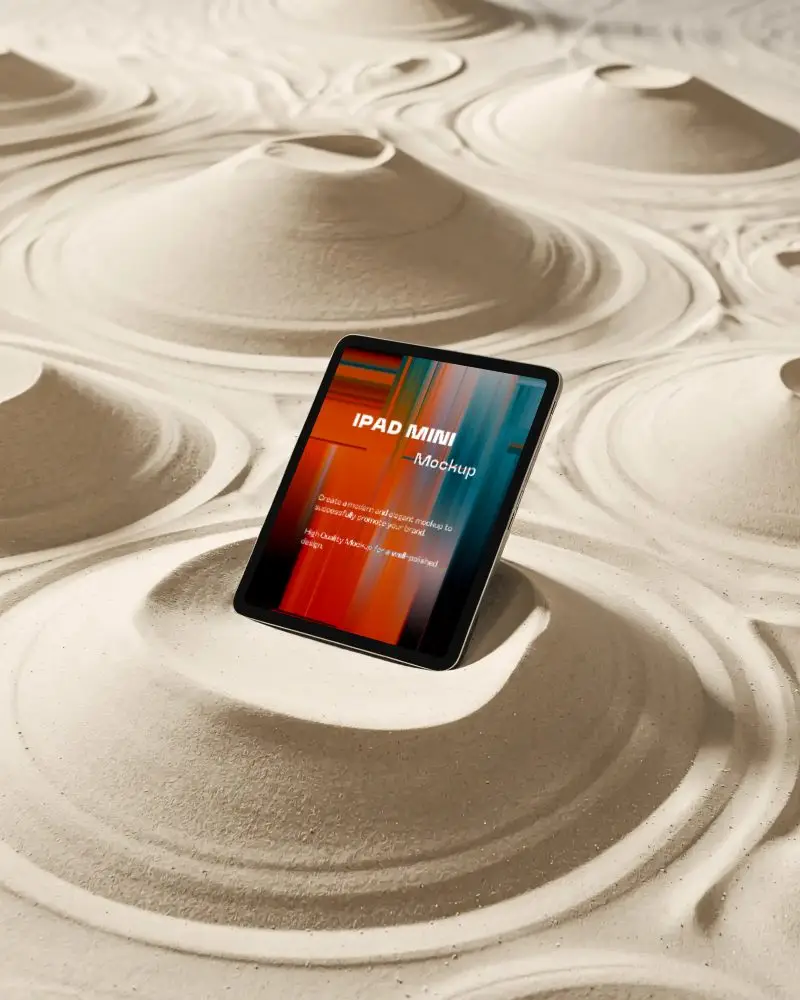ipad-mini-mockup-nestled-in-sculpted-sand-dunes-with-organic-ripple-textures-and-light