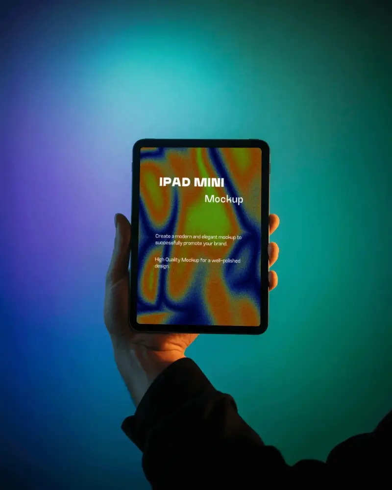 Ipad Mini Vertical Mockup Hand Holding Digital Tablet Against Glowing Purple Teal Gradient Light