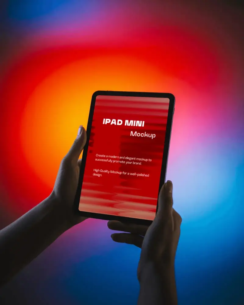 Ipad Mini Mockup Held In Hands Against Vivid Red Blue Gradient Background