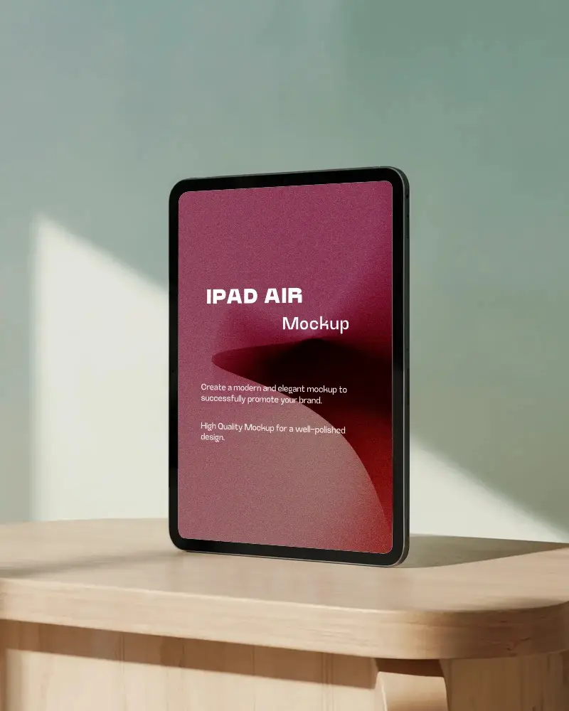 Standing Ipad Mockup On Light Wood Table With Soft Shadow Play And Pastel Wall Modern And Artistic Display Scene