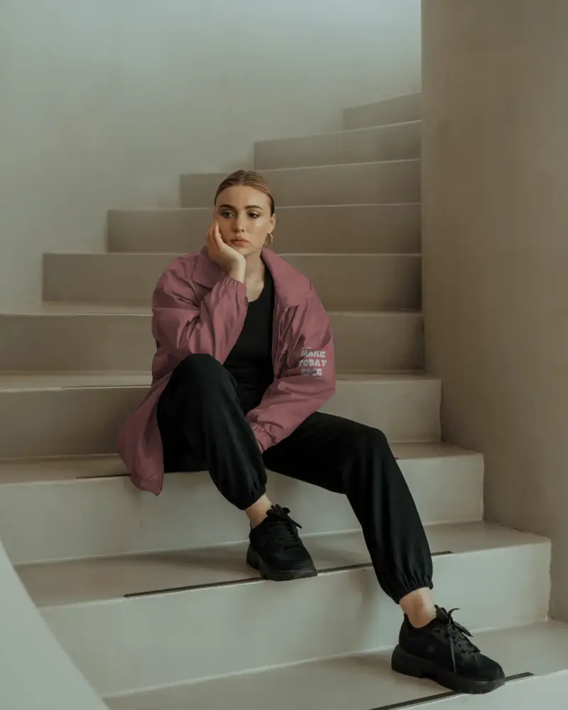 Modern Athleisure Jacket Mockup Woman Wearing Relaxed Fit Windproof Outerwear Sitting On Steps