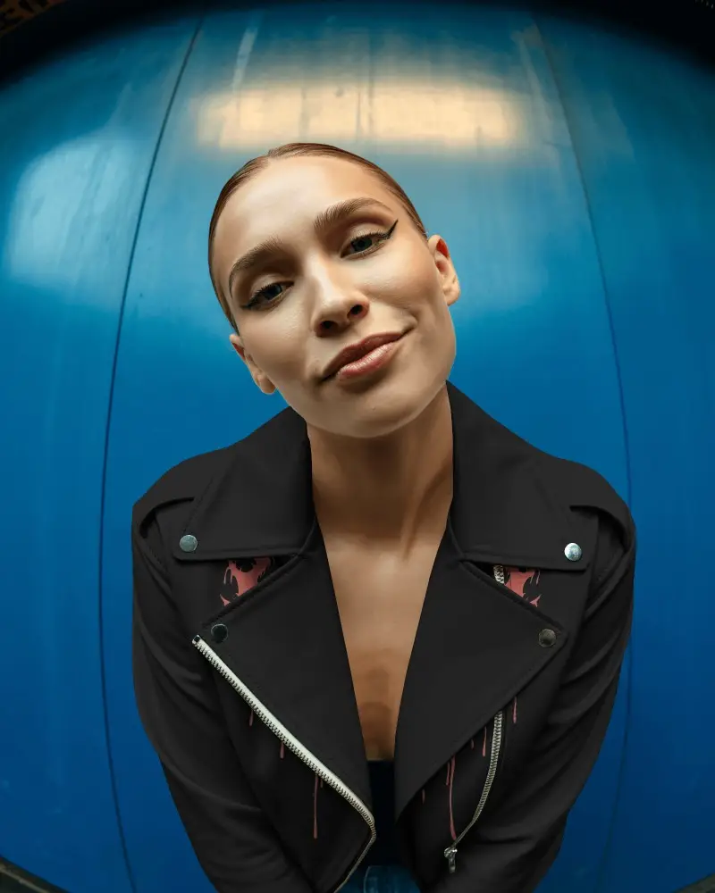 Womens Leather Jacket Mockup Fisheye Portrait Edgy Urban Style Blue Wall Backdrop