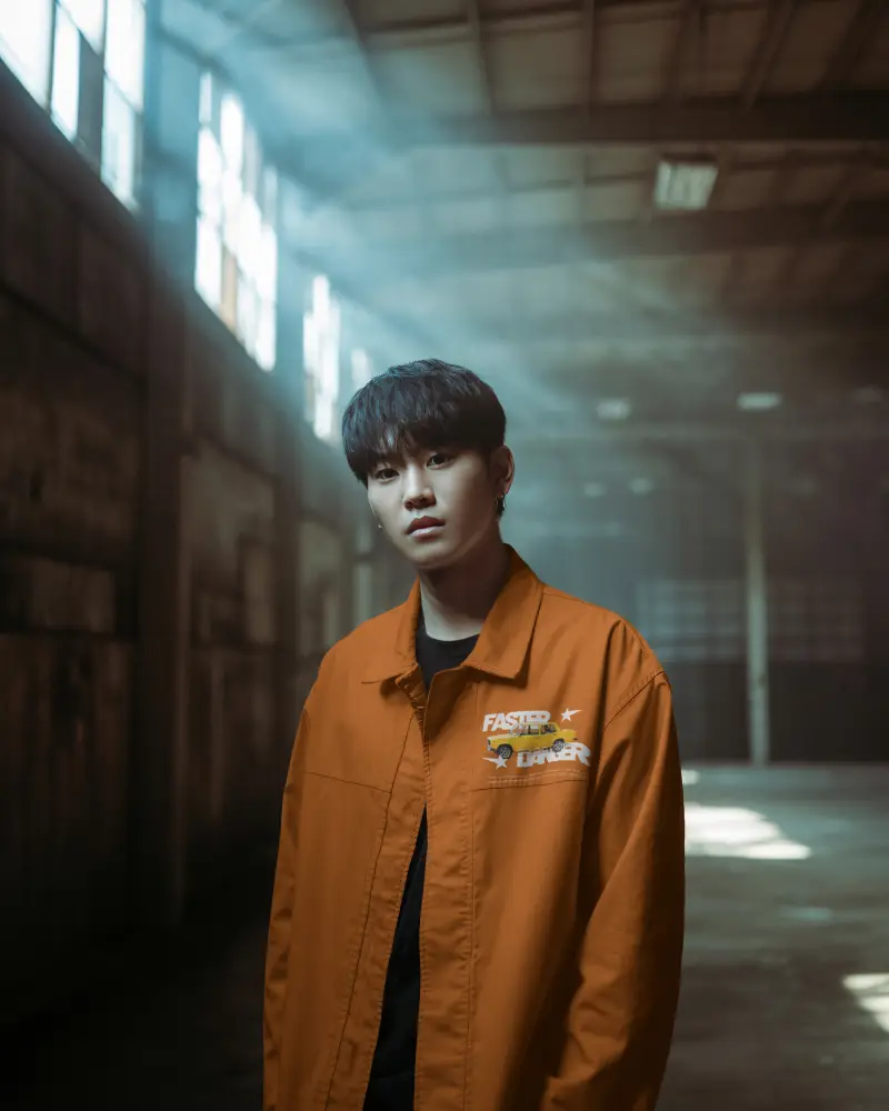 Moody Warehouse Jacket Mockup Male Model Standing Alone With Cinematic Light And Depth Perspective