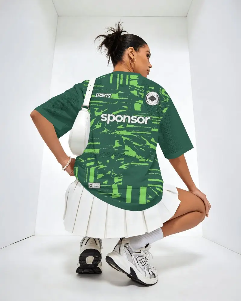 Back View Oversized Jersey Mockup Female Model Crouching In White Studio With Sporty Streetwear Look