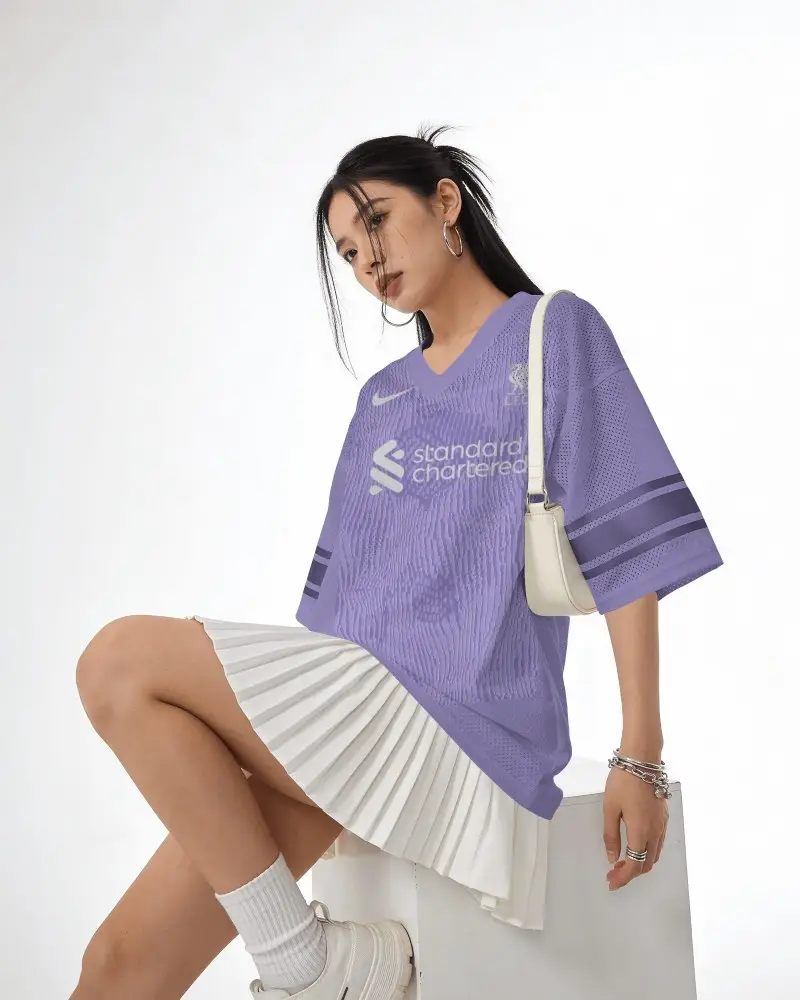 V Neck Mesh Football Jersey Mockup Female Model Seated Side Pose In Clean White Studio
