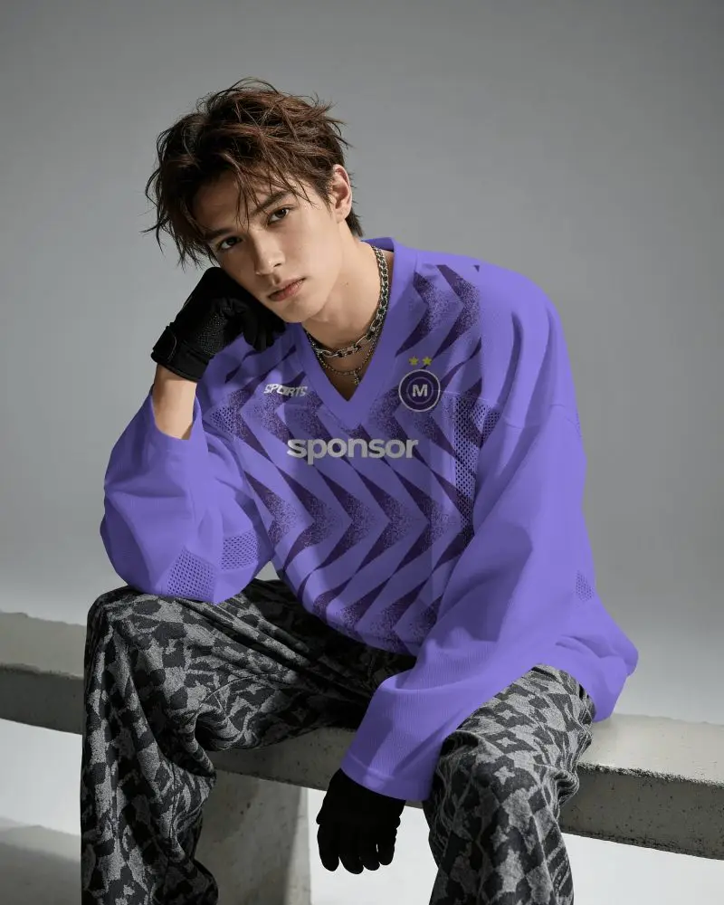 Oversized Long Sleeve V Neck Basketball Jersey Mockup Male Model Seated In Gray Studio With Lighting