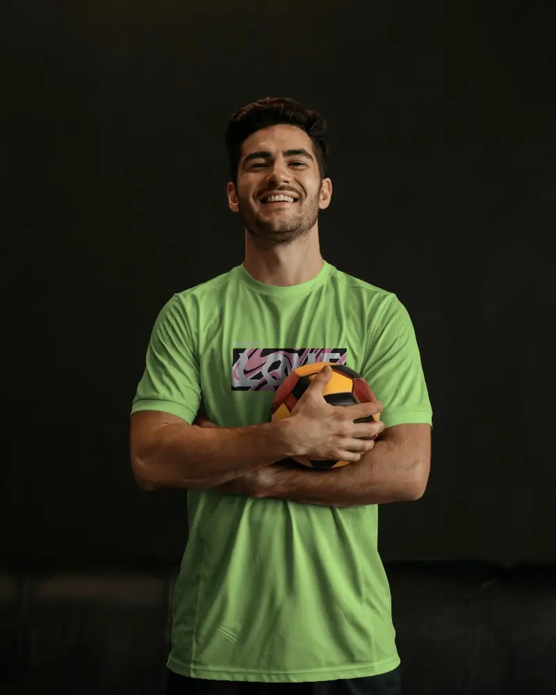 Casual Soccer Jersey Mockup Male Model Laughing Holding Ball Black Background Custom Design Display