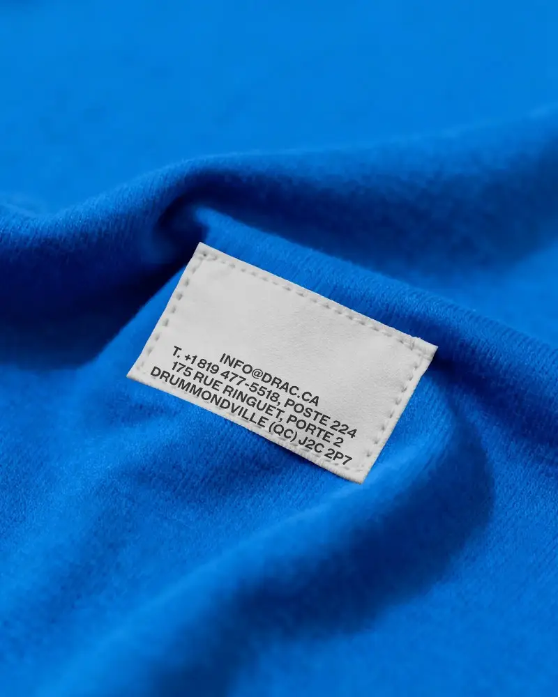 Blank Stitched Fabric Label On Soft Textured Clothing Material Closeup For Branding