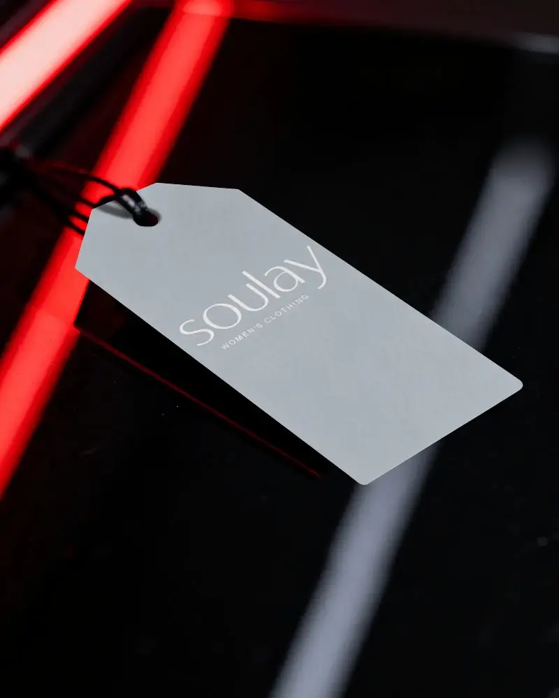 Blank Rectangular Price Label Tag On Dark Glossy Surface For Product Packaging Presentation
