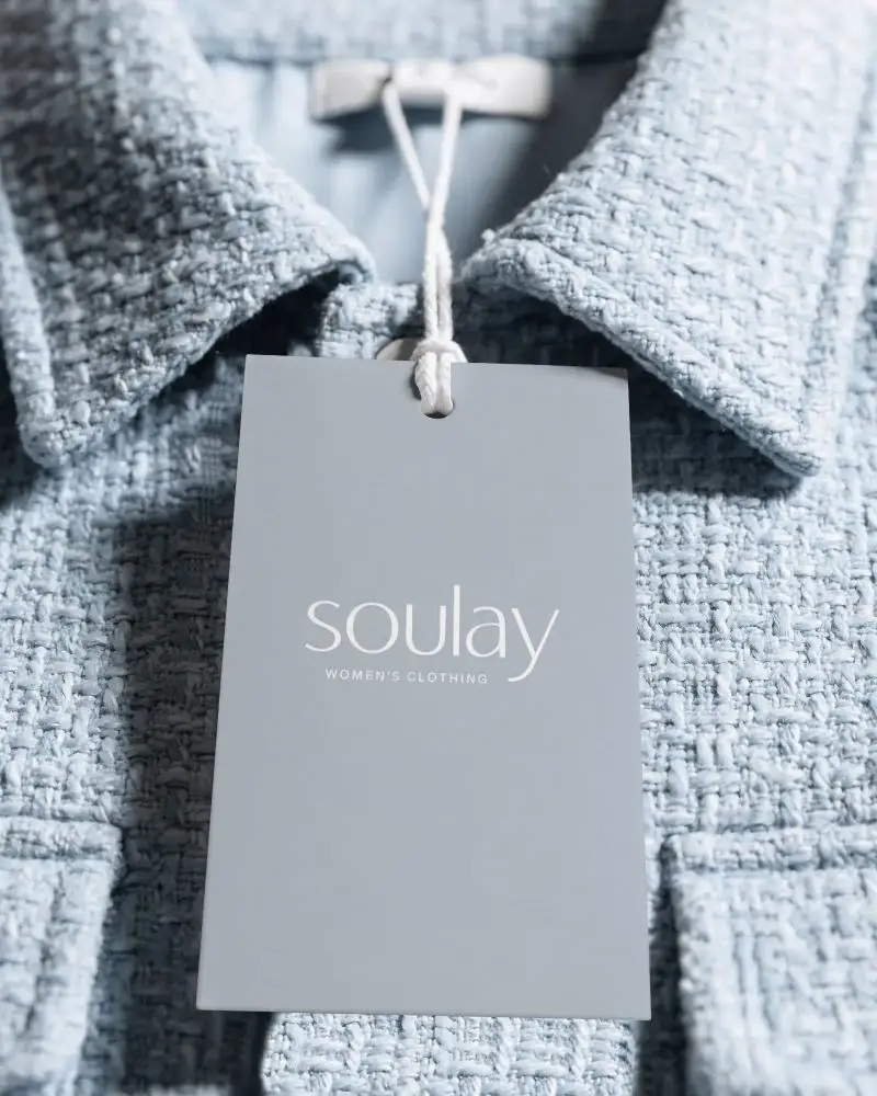 Editorial Clothing Label Mockup On Textured Jacket Collar With Boutique Branding Aesthetic
