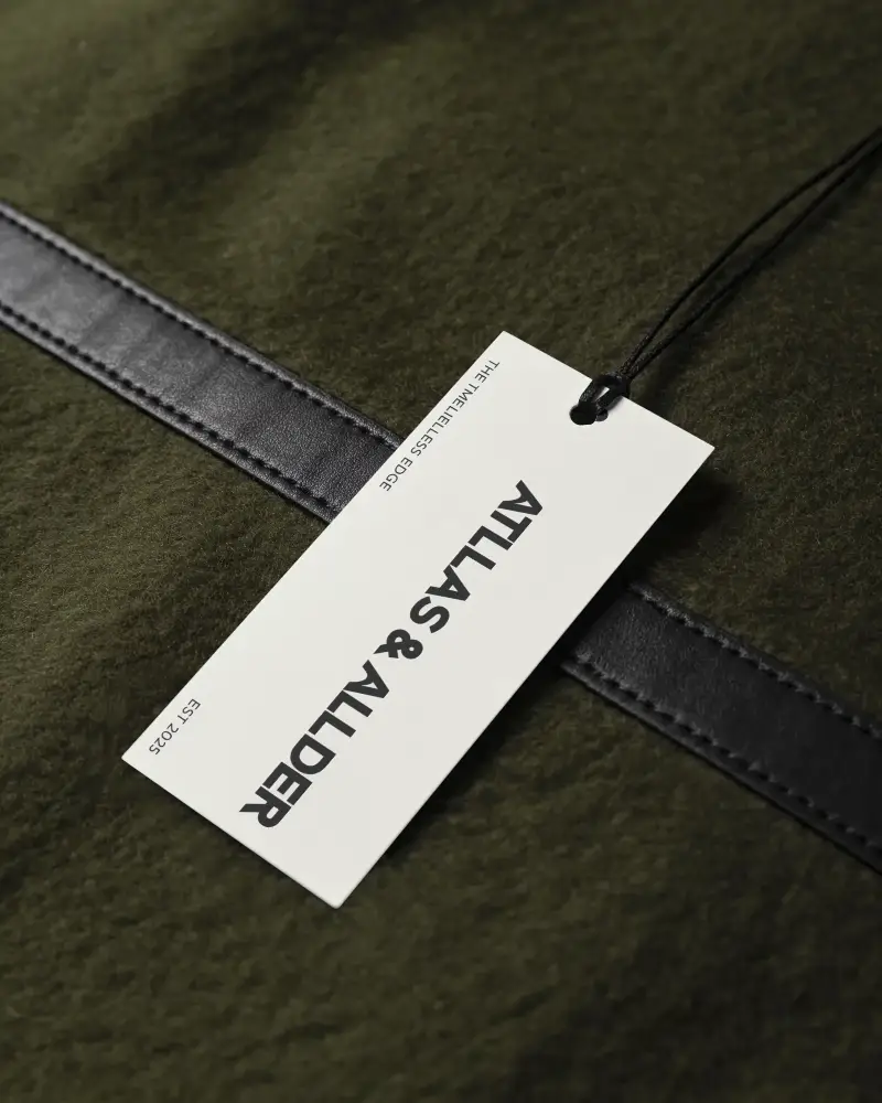Blank Fashion Clothing Label Mockup With String On Textured Fabric Background For Branding