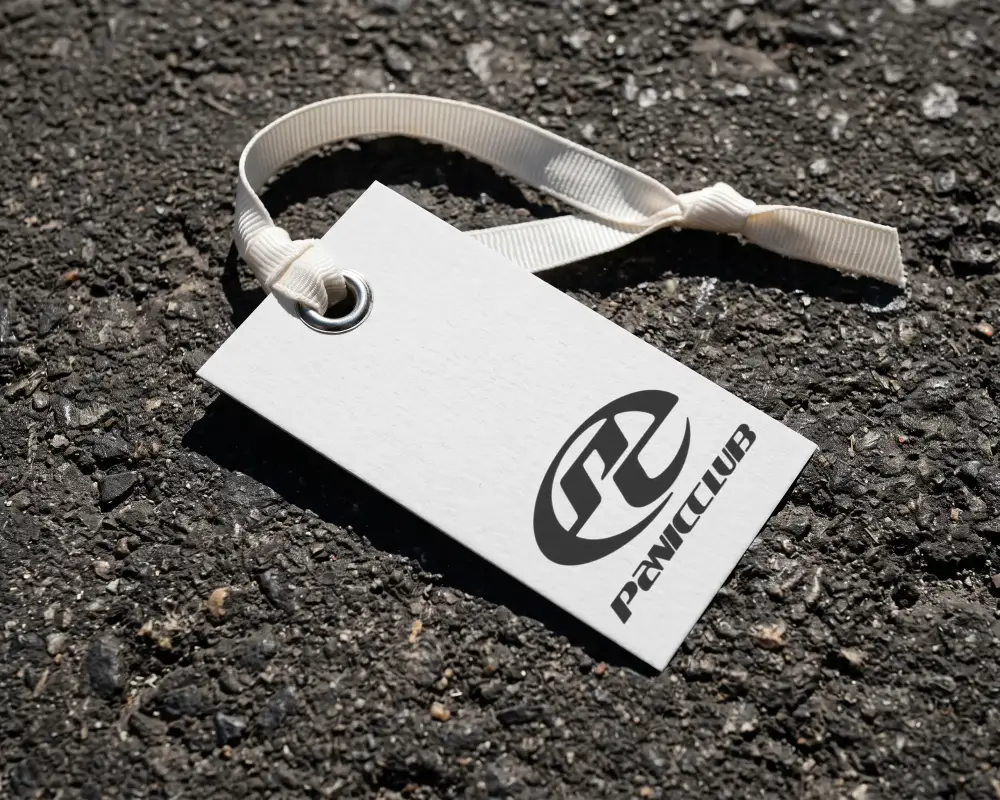 Blank Textured Hanging Label Mockup With Metal Eyelet And Fabric Tie On Rough Surface Background