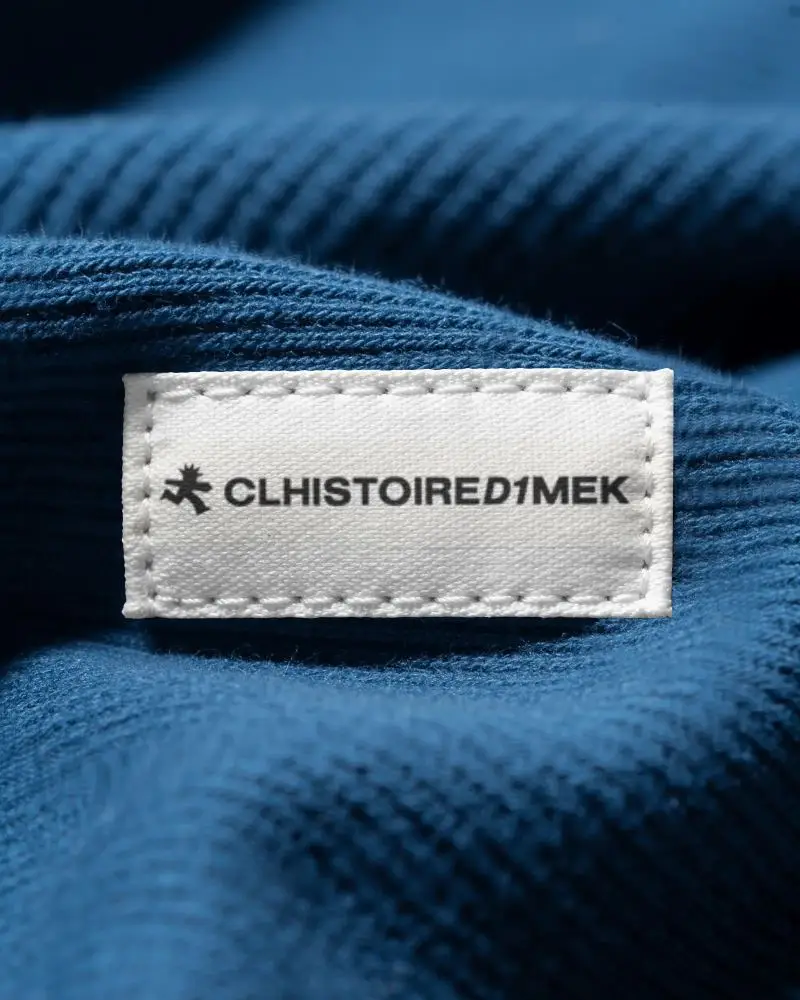Blank Stitched Fabric Label On Textured Clothing Closeup For Fashion Brand Labeling