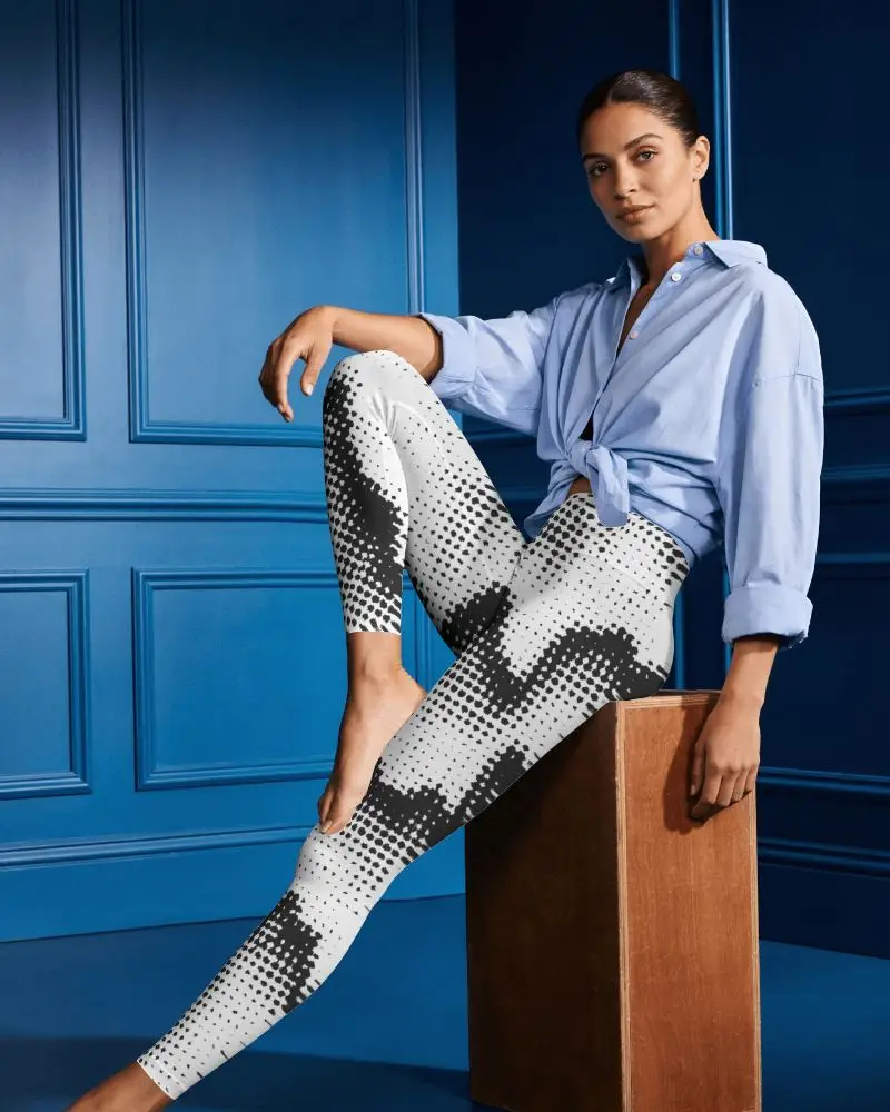  editorial Womens Leggings Mockup With Seated Female Model And One Leg Extended In Luxury Interior