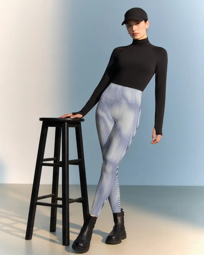 Standing Model High Waist Leggings Mockup Beside Stool In Minimal Studio Setting