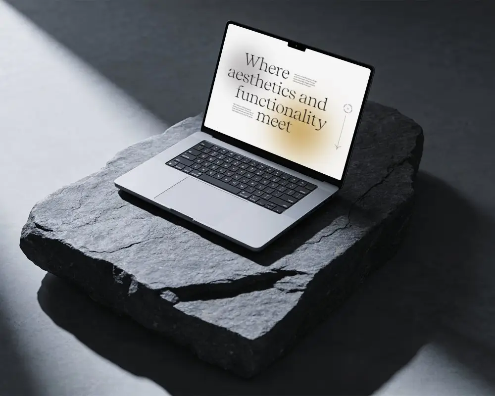 Professional Macbook Pro M4 Mockup Showcased On Raw Rock Base With Muted Dark Ambient Light