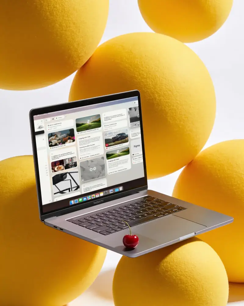 Modern Macbook Pro M1 Mockup Floating Among Large Soft Spheres With Cherry On Keyboard