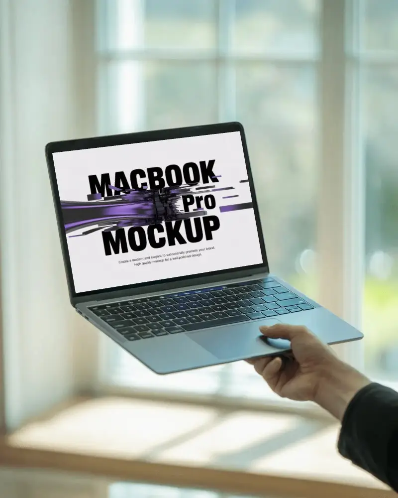 Macbook Pro M1 Mockup Held By Hand In Front Of Bright Window With Soft Daylight Glow