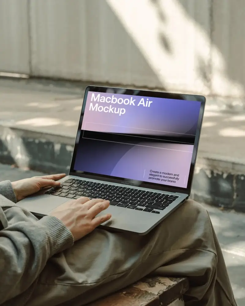 outdoor-macbook-m1-air-mockup-on-lap-in-natural-light-with-shadow-texture-and-relaxed-pose
