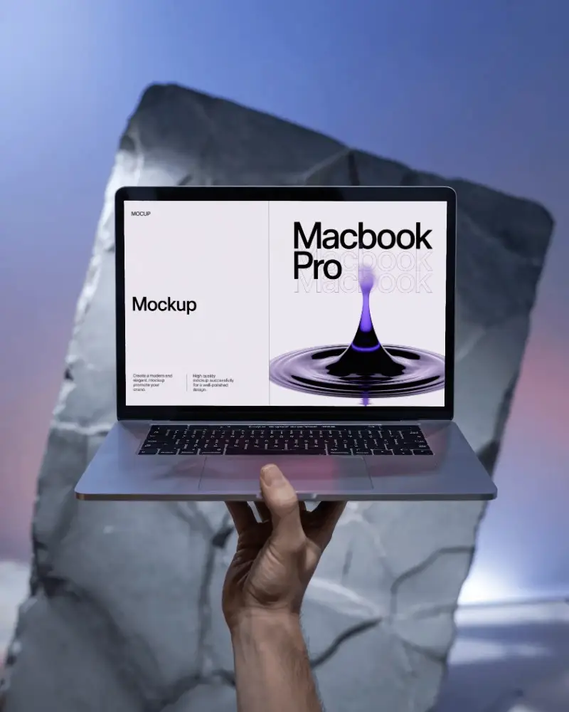 macbook-m1-pro-mockup-held-high-in-front-of-angular-stone-slab-with-soft-sky-gradient
