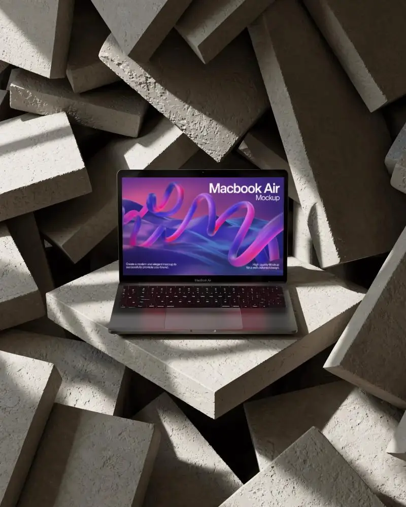 macbook-air-m1-mockup-on-angled-concrete-slab-stack-with-dramatic-light-shadow-texture-depth
