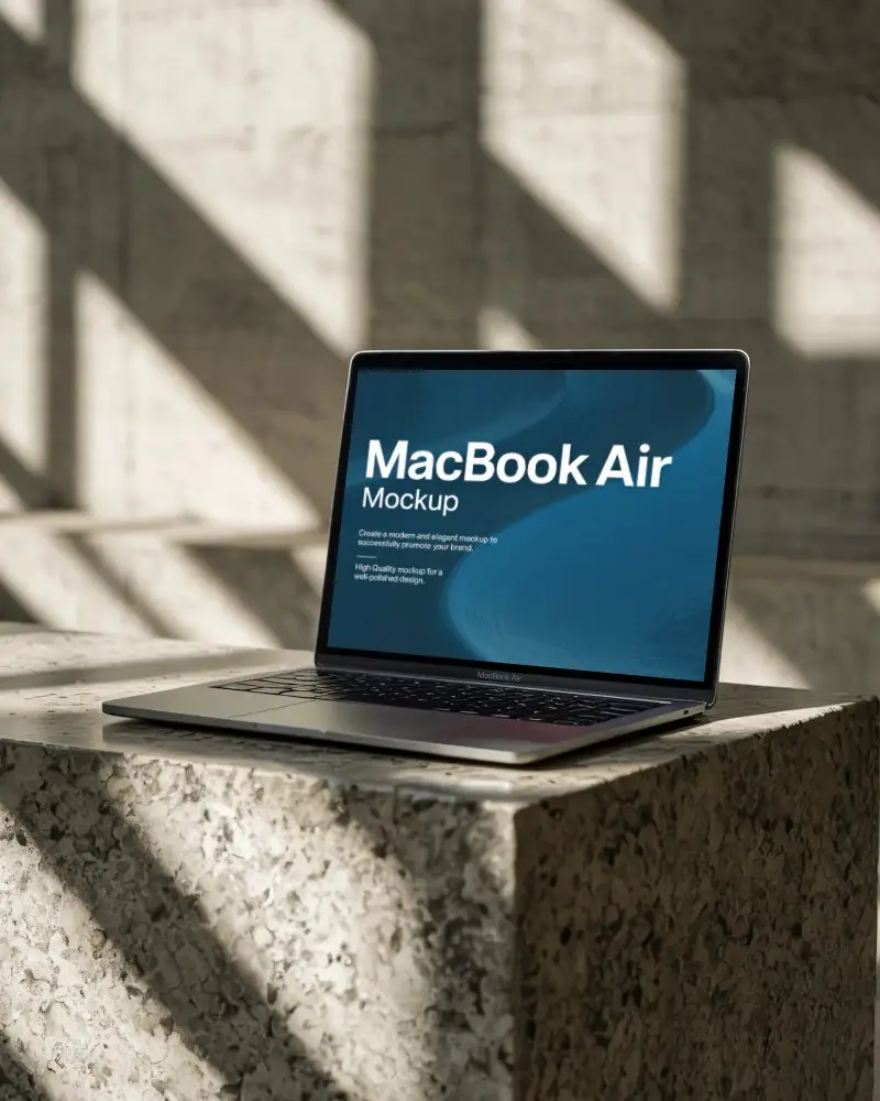 M1 Air Mockup On Textured Stone Block With Sunlit Shadows In Architectural Concrete Space