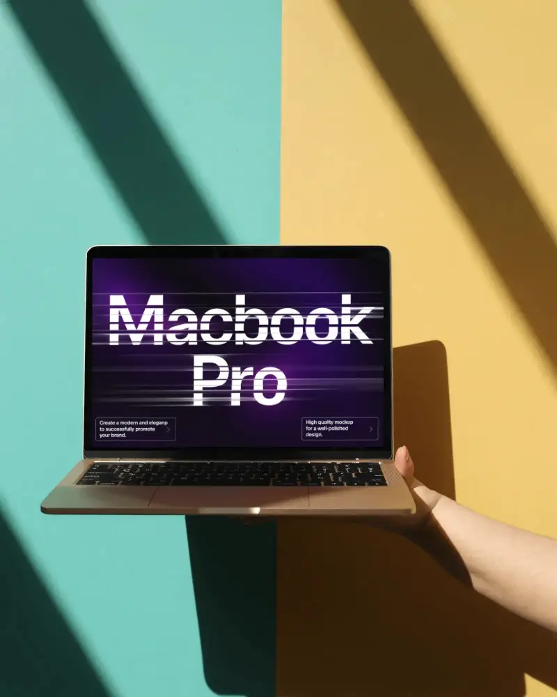 Bold Dual Tone Minimalist M1 Pro Mockup Held Against Teal And Yellow Background