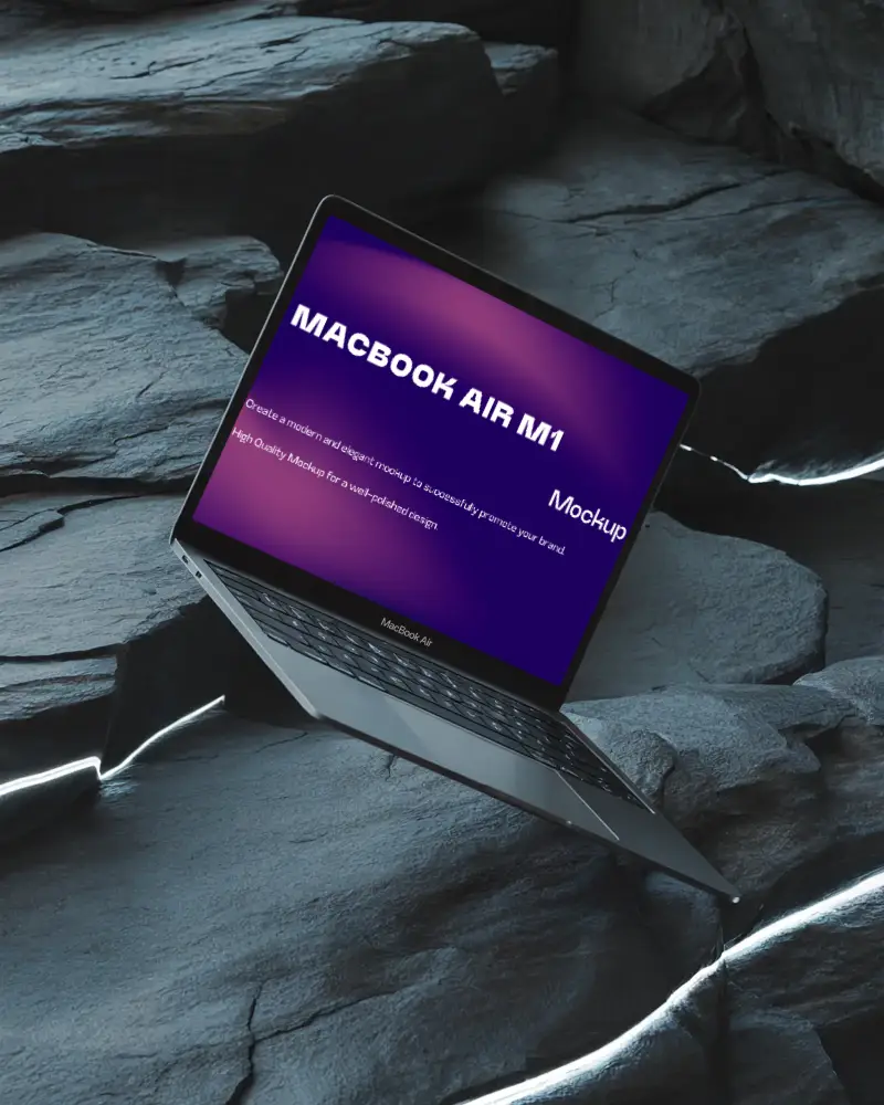 Macbook Air M1 Mockup Angled Over Cracked Slate Rocks With Glowing Light Veins And Cool Toned Textures Futuristic And Dramatic Look
