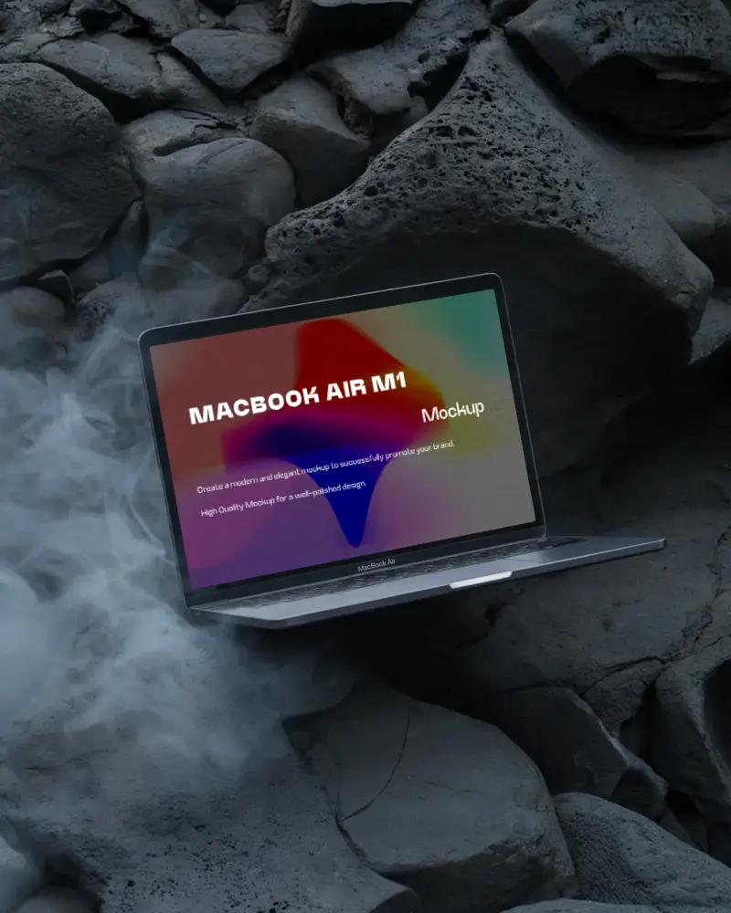 Macbook Air M1 Mockup Tilted On Dark Volcanic Boulders With Thick Curling Smoke Moody And Raw Geological Atmosphere