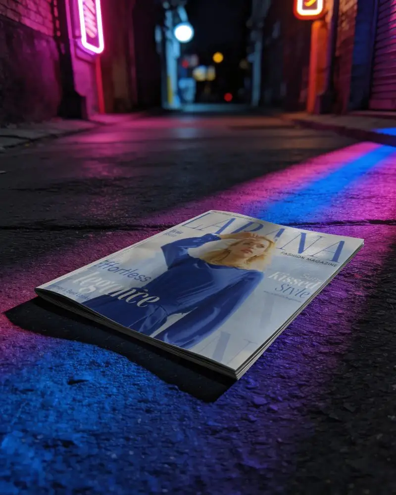 Urban Magazine Mockup Placed On Textured Asphalt With Vivid Neon Glow And Bokeh