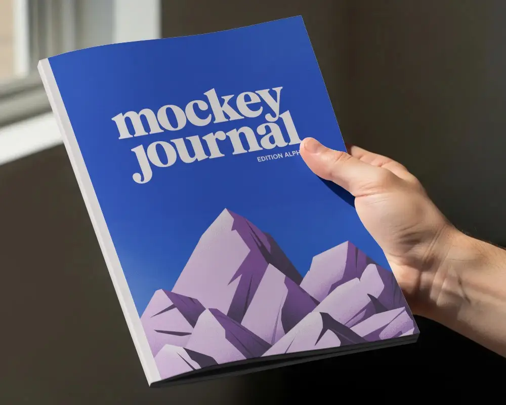 Person Holding Minimalist Magazine Mockup Against Dark Background In Digital Presentation