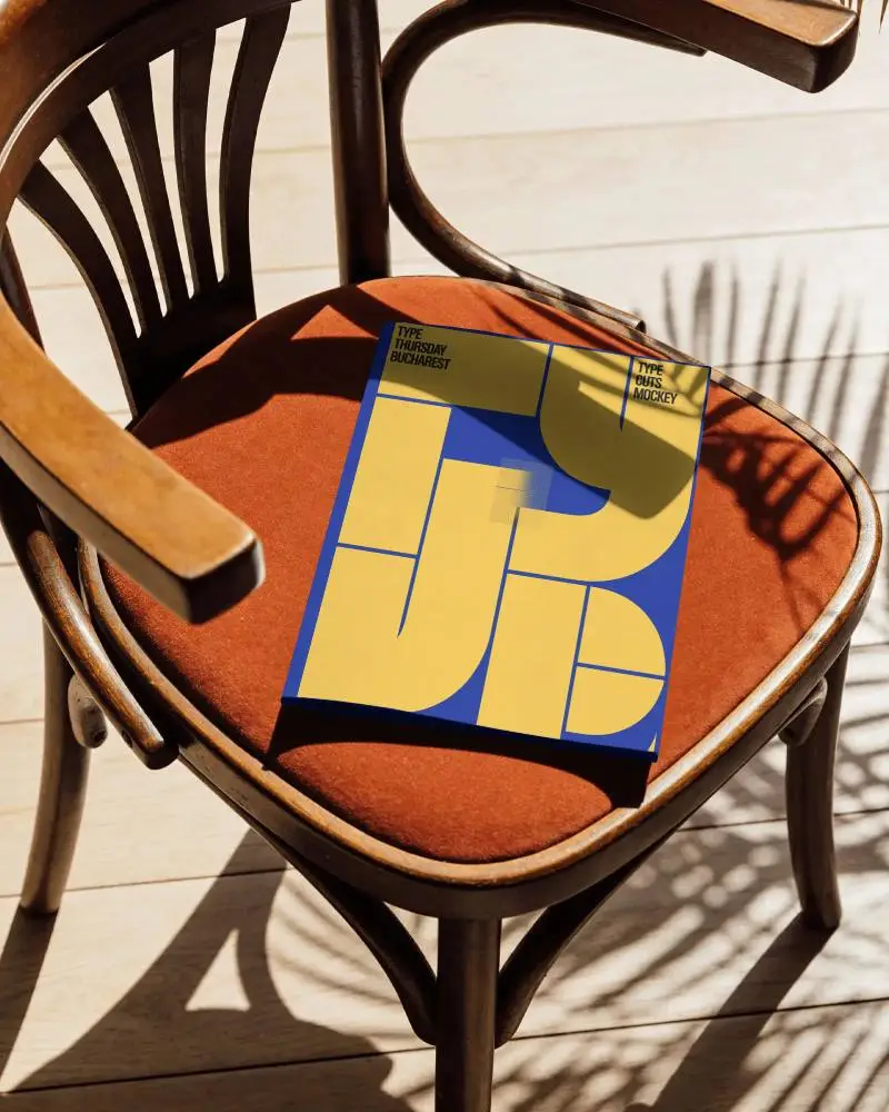 Outdoor Lounge A4 Magazine Mockup Placed On Cushioned Chair With Tropical Leaf Shadows And Daylight