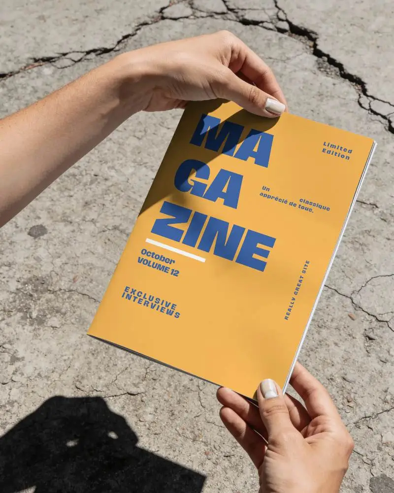Hands Holding Magazine Mockup On Cracked Concrete Ground Texture Background