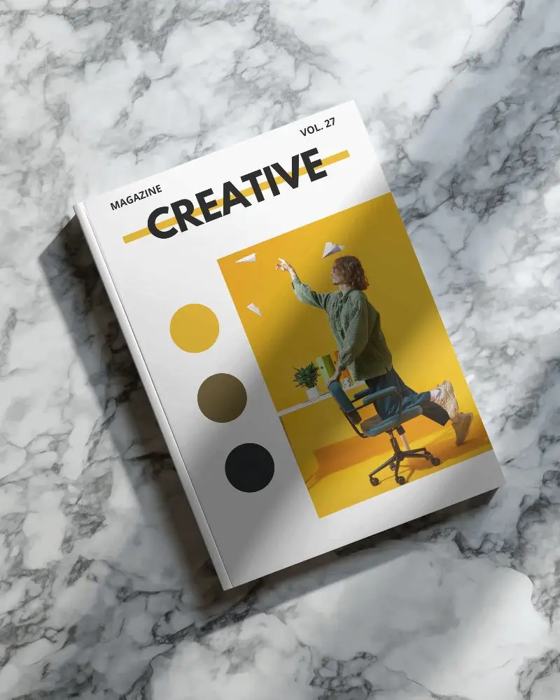 Hardcover Magazine Mockup Showing Top View On Marble Surface With Natural Light Shadow