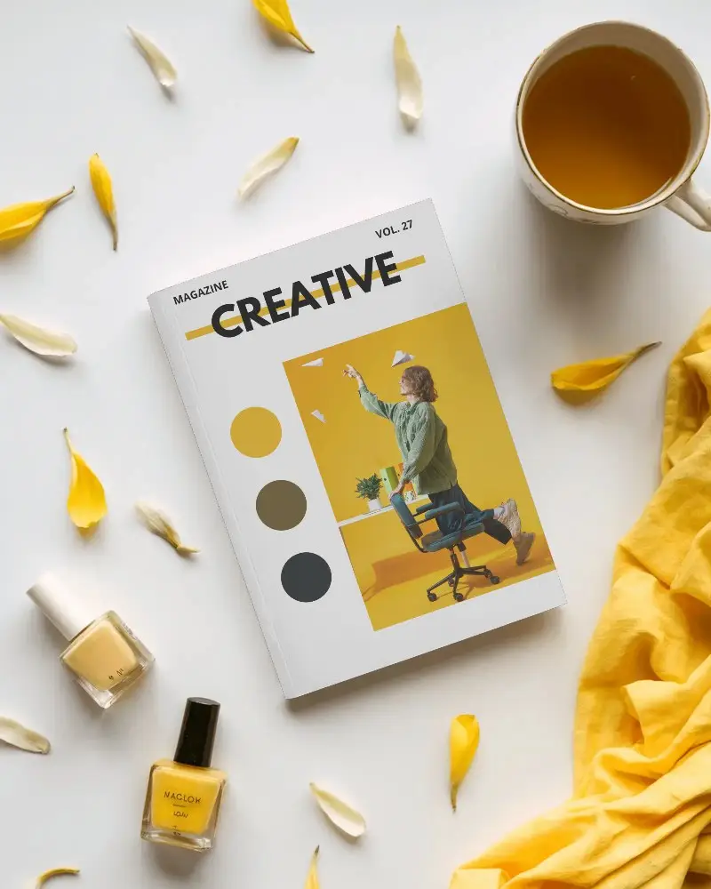Elegant Softcover Magazine Mockup Surrounded By Yellow Themed Accessories