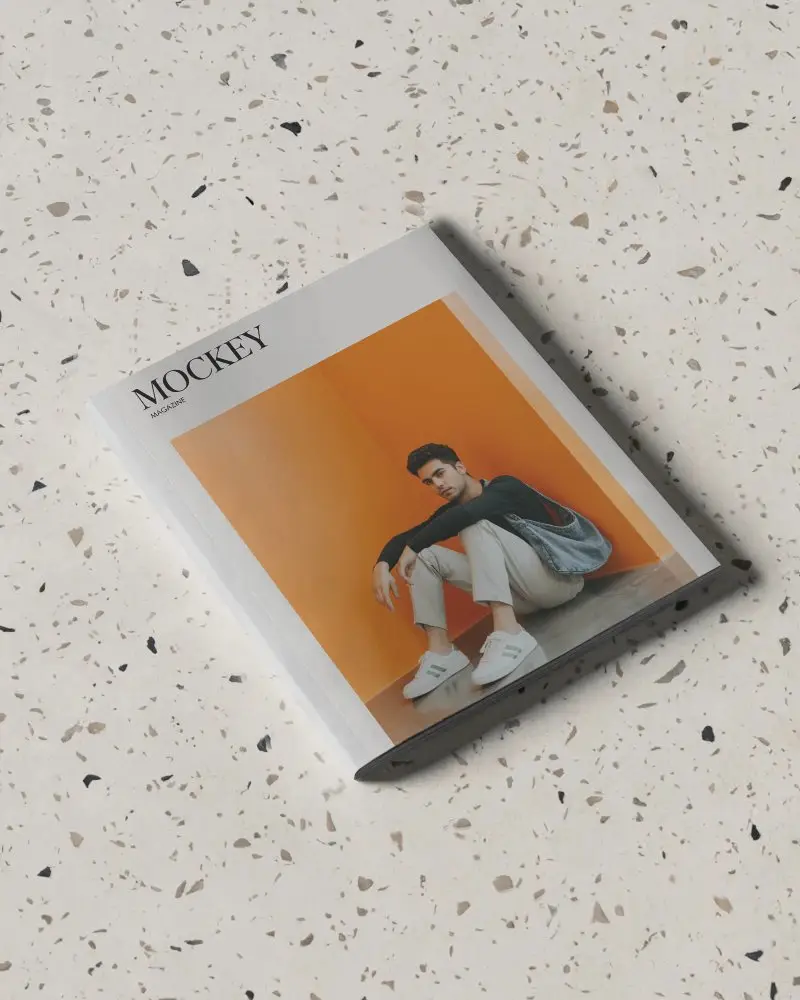 Premium Softcover Magazine Mockup On Textured Terrazzo Surface For Design Presentation